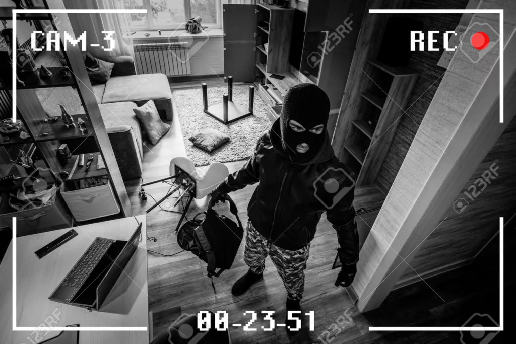 189161346 a man in a black mask is trying to rob a house simulation of recording from a surveillance video 1